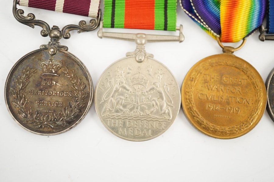 A medal group comprising of a Meritorious Service medal, a 1939 to 1945 Defence Medal, and a First World War trio awarded to 3824 SJT. F.W.G. Wakefield. R.F.A., together with a Delhi Durbar Medal 1911, crudely engraved t